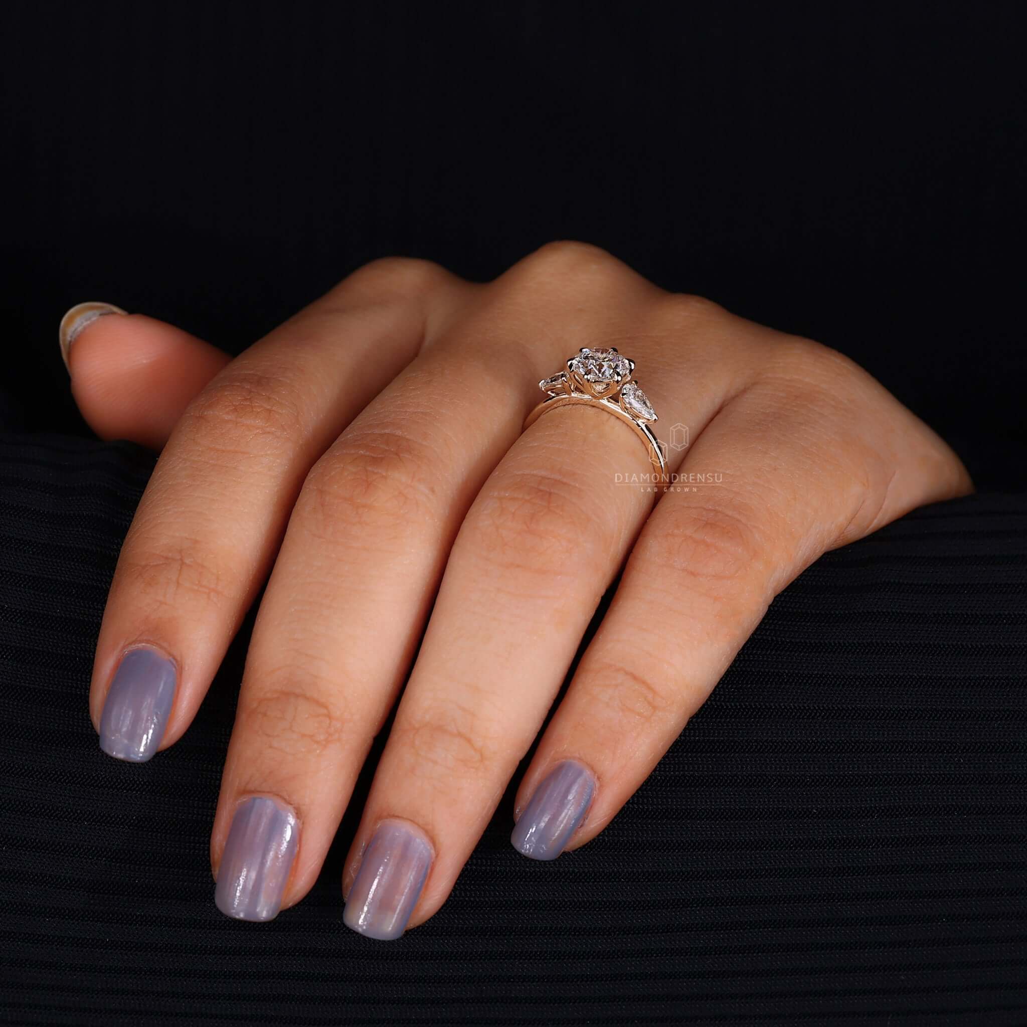 A bespoke engagement ring with pear side stones, ideal for special occasions.