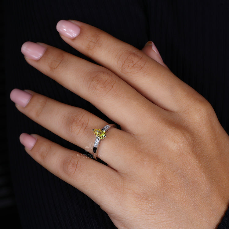 White gold ring styled as yellow pear diamond ring.
