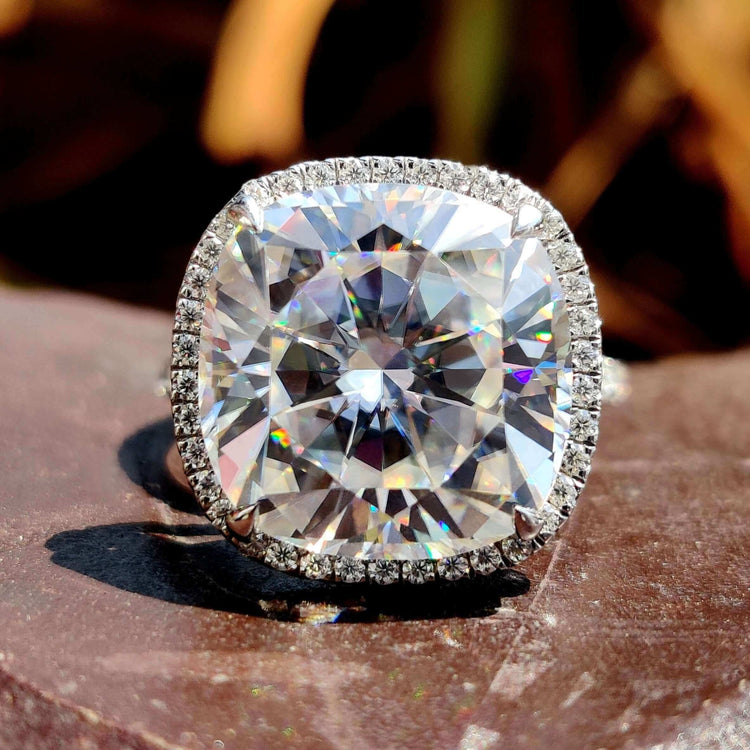 Cushion cut halo engagement ring in white gold.

