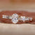 Oval diamond engagement ring with pave band.
