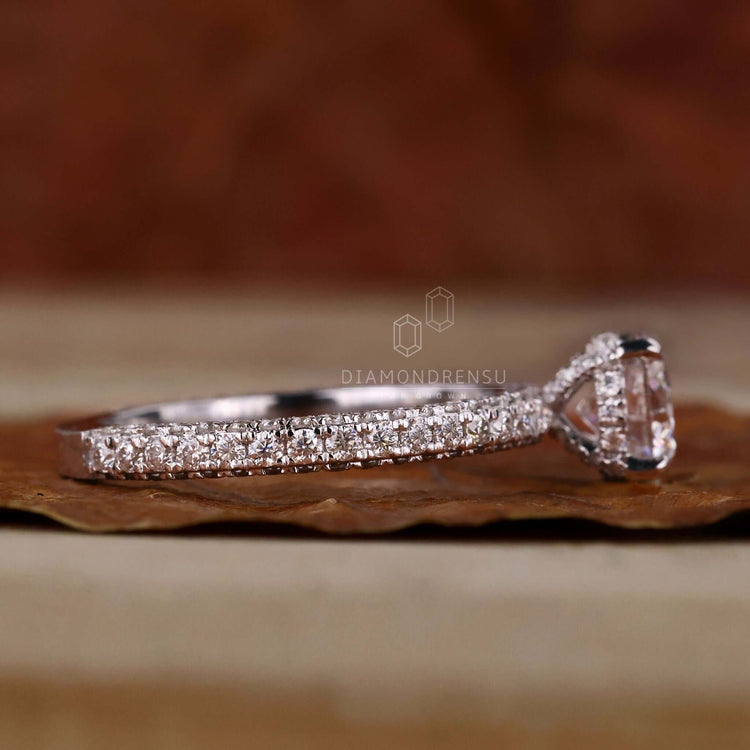 Pave engagement ring featuring a round cut diamond and a unique hidden halo design for unforgettable proposals.
