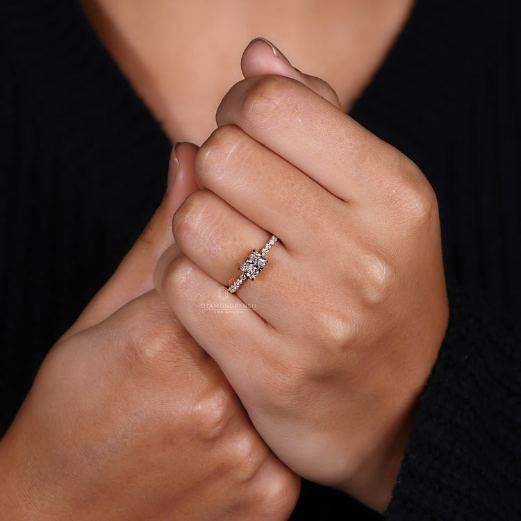 UK engagement ring featuring radiant diamond and round diamond pave band.
