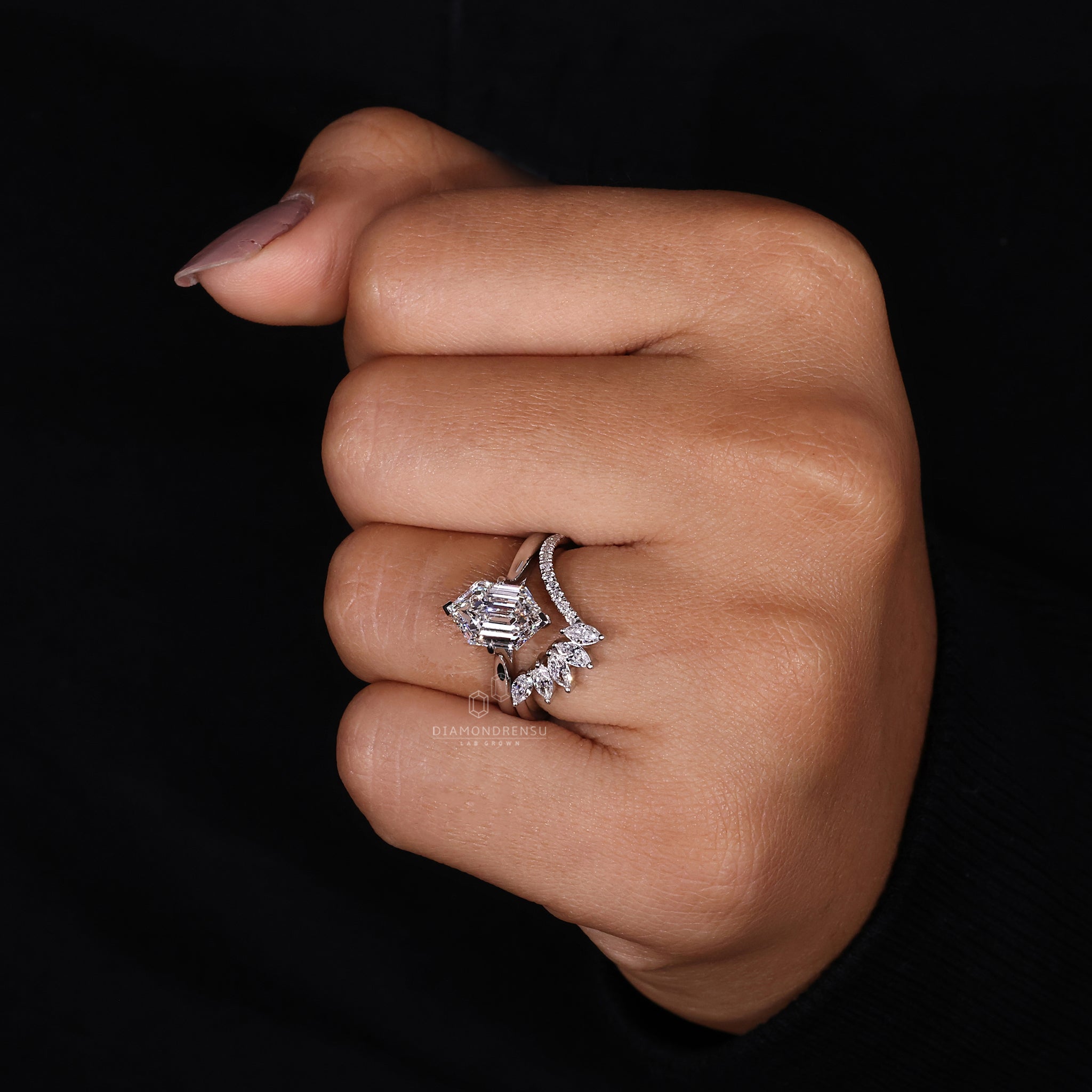 Buy bridal set featuring a hexagon step cut centre stone and compass setting.
