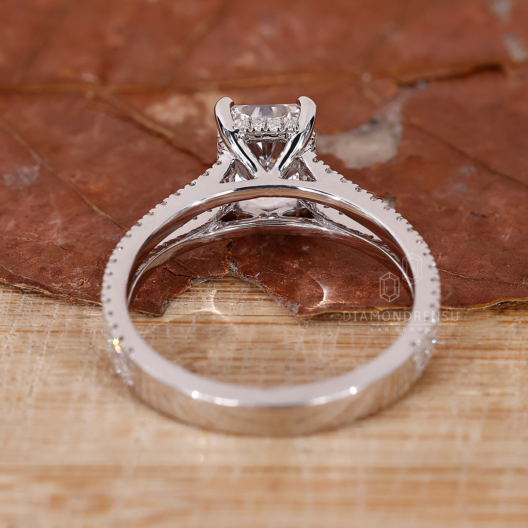 Elegant engagement ring with hidden halo and radiant cut diamond.
