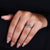 Round side stones held by prong setting.

