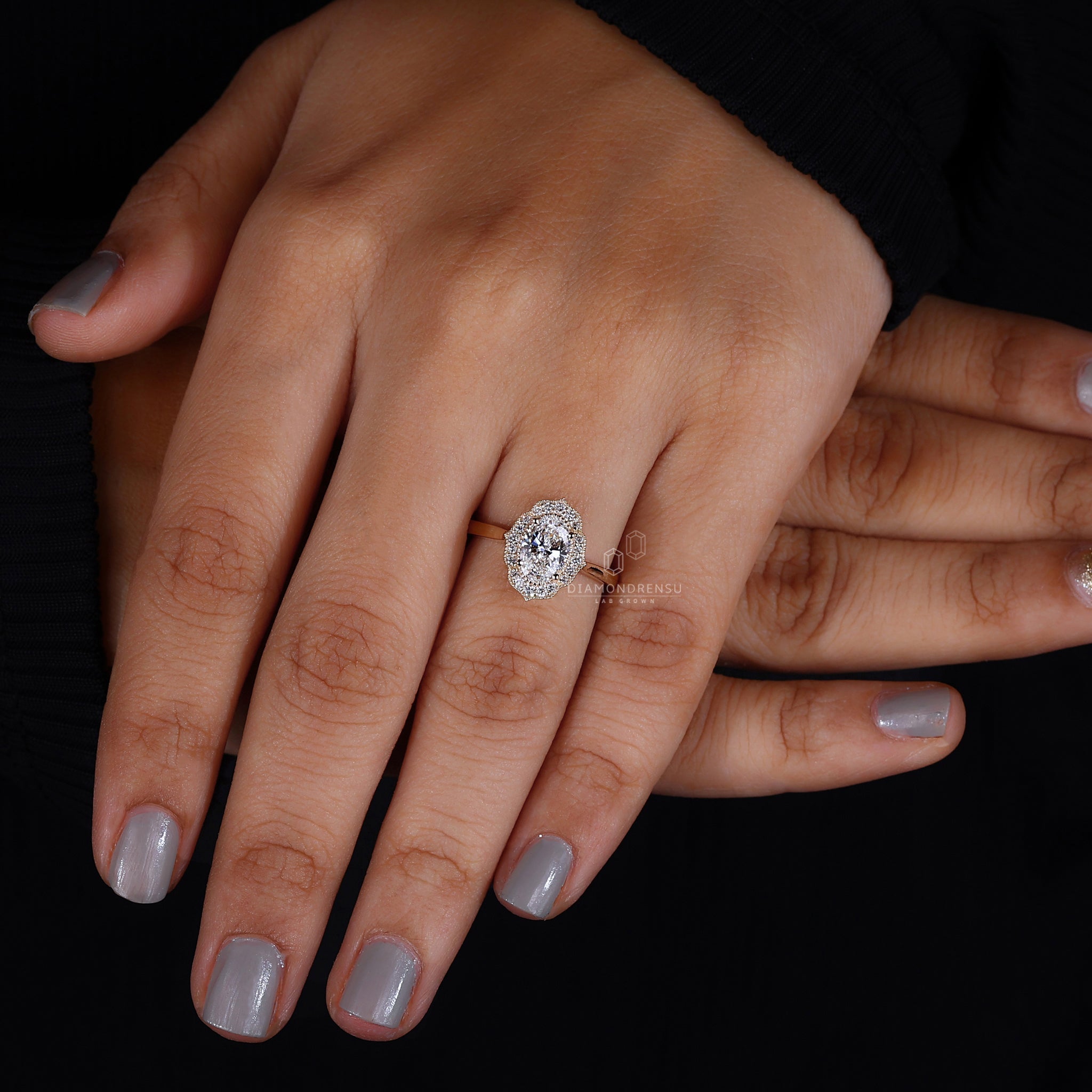 Oval halo ring featuring a radiant diamond encircled by a sparkling halo.