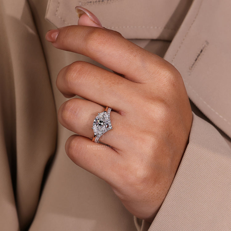 White and rose gold ring with prong setting and V shaped prong ring.
