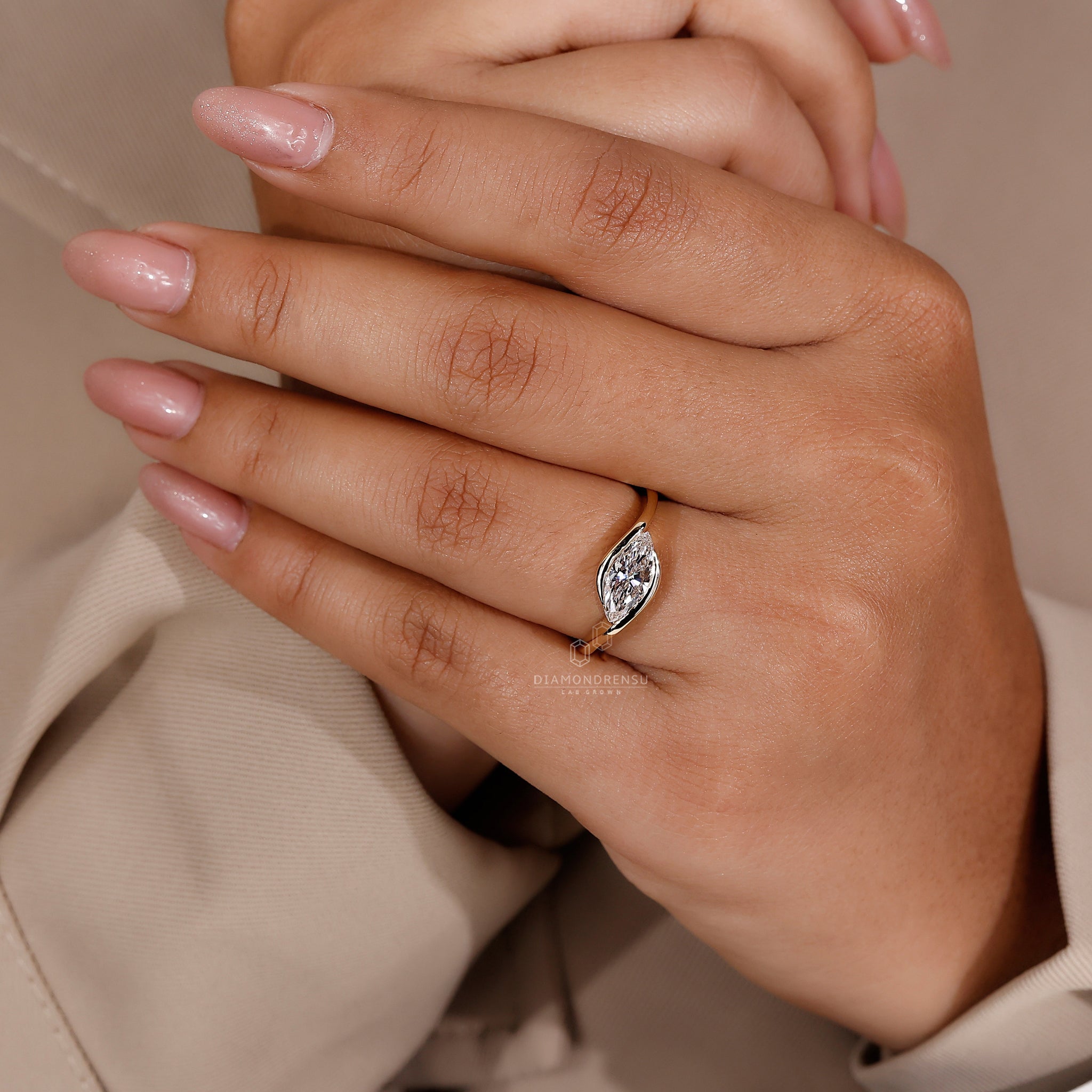 Handmade ring in yellow gold with a sleek east west diamond design.
