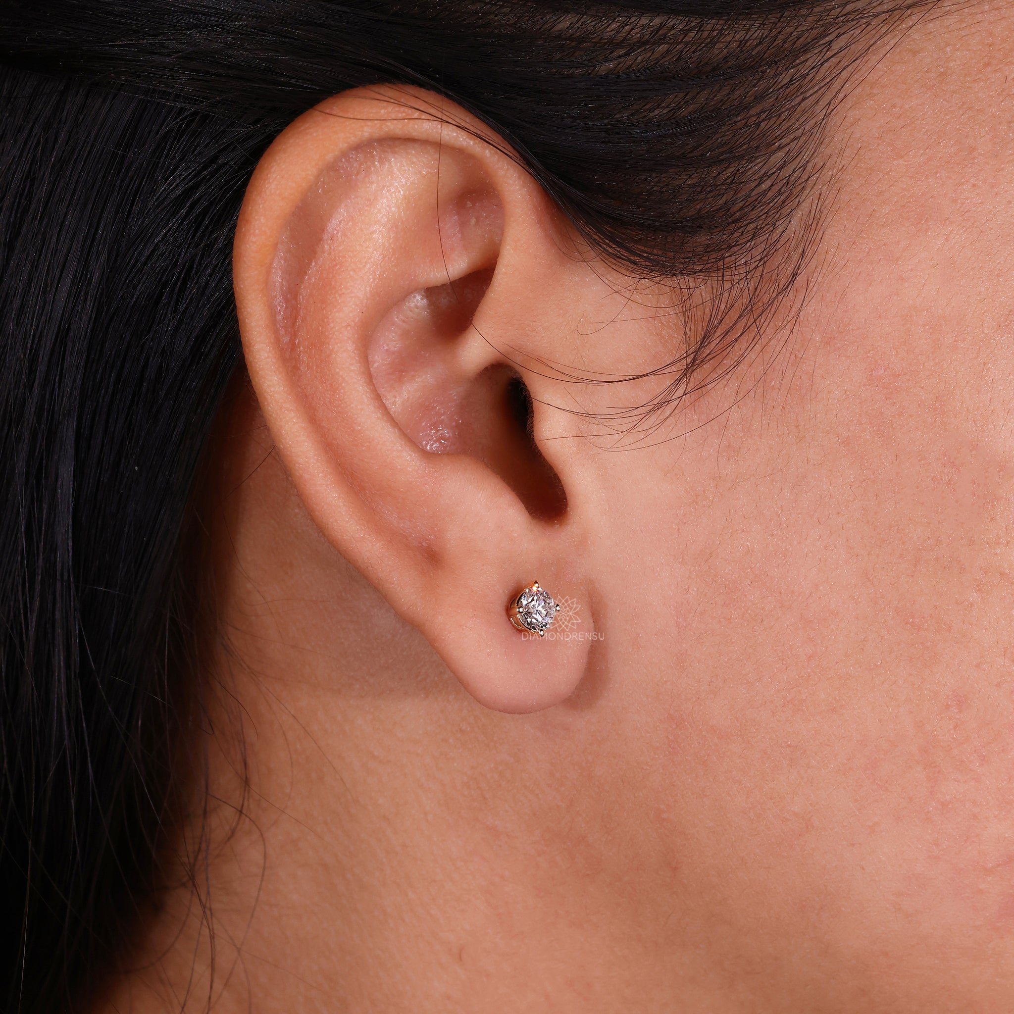 Handmade jewellery showcasing yellow gold stud earrings with diamonds.