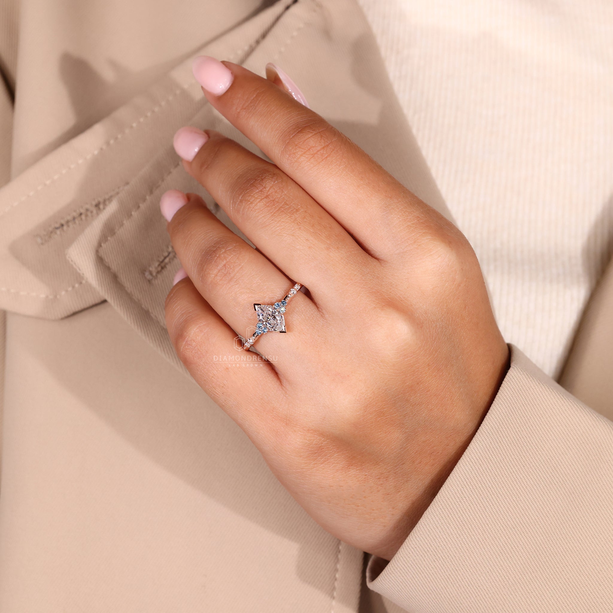 The UK engagement ring shines with marquise and round side stones.
