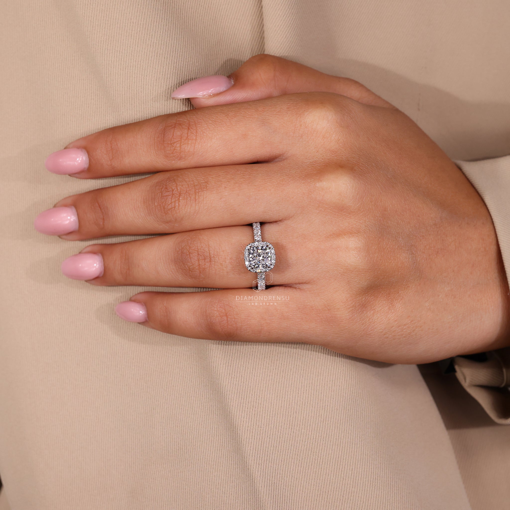 Cushion cut halo diamond ring with handmade jewellery details.
