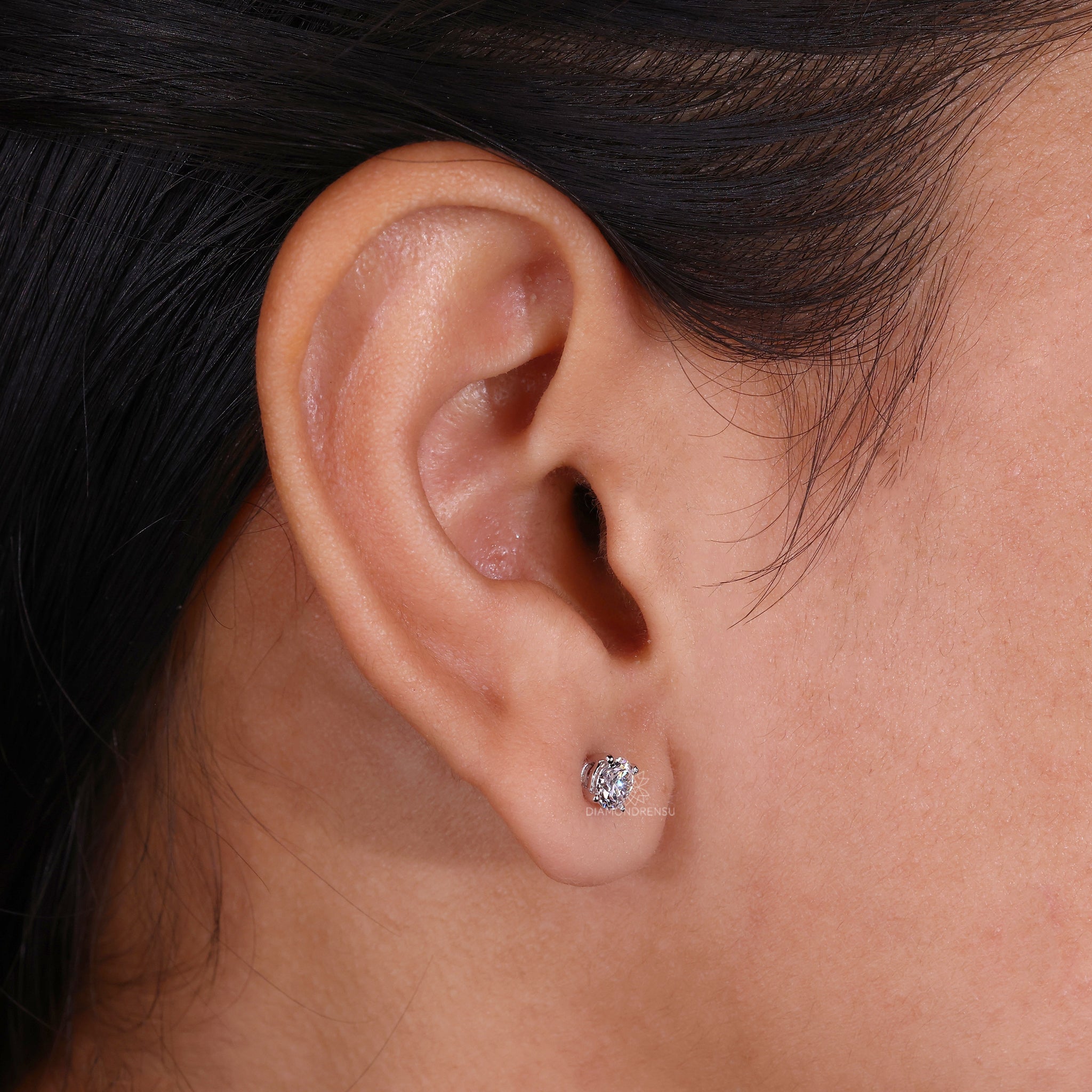 Custom diamond earrings crafted as simple round studs in white gold.