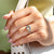 White gold engagement ring featuring oval and half moon diamonds.
