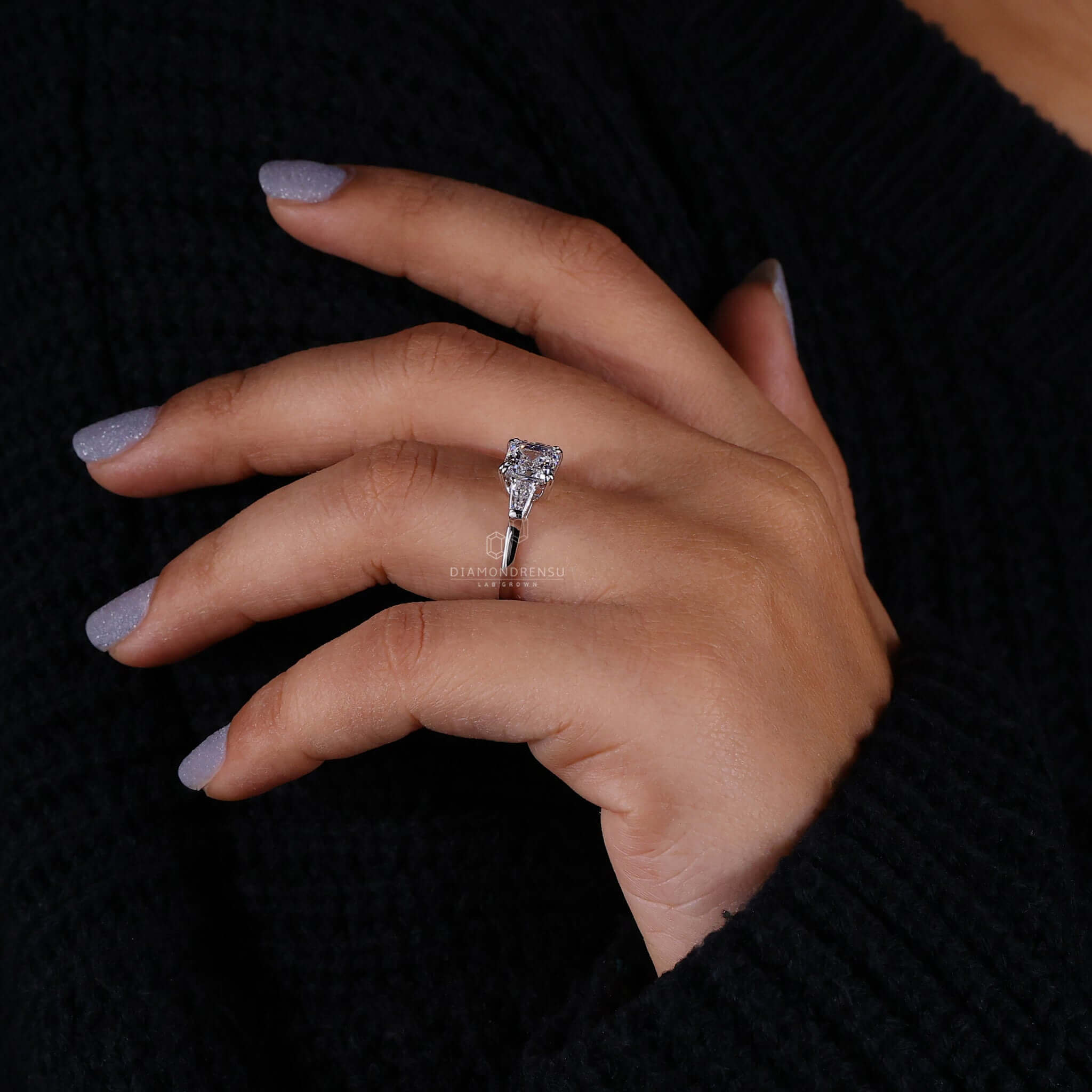 Diamond ring with tapered baguettes and a 4 prong claw setting perfect for a classic engagement ring for women.
