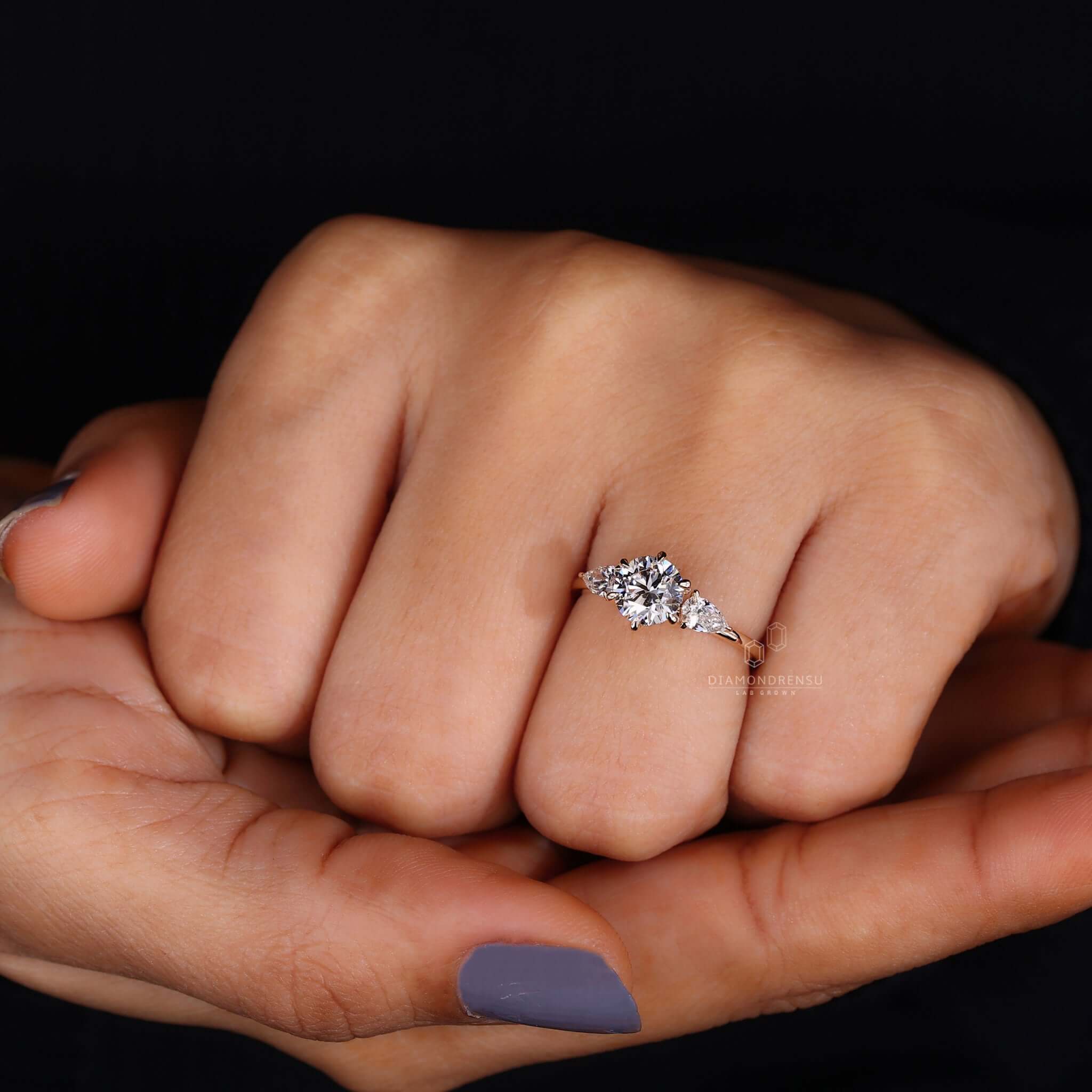 A radiant pear shaped diamond ring featuring a unique design.