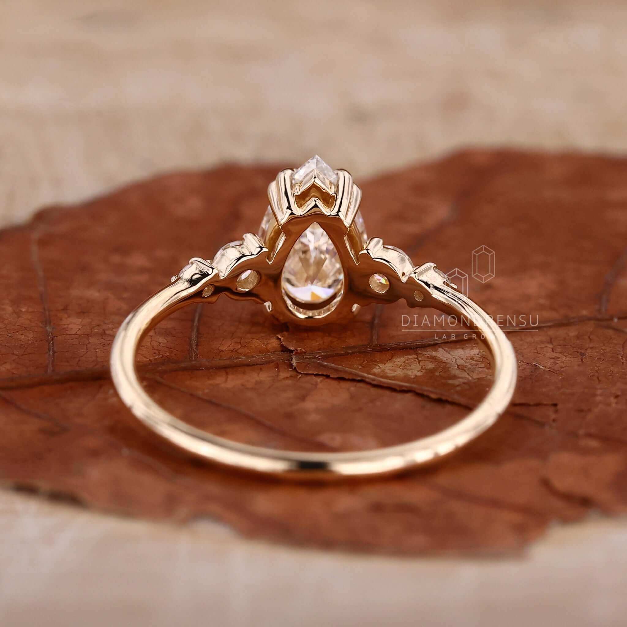 Pear shaped ring paired with a unique engagement ring design and handmade jewellery craftsmanship.