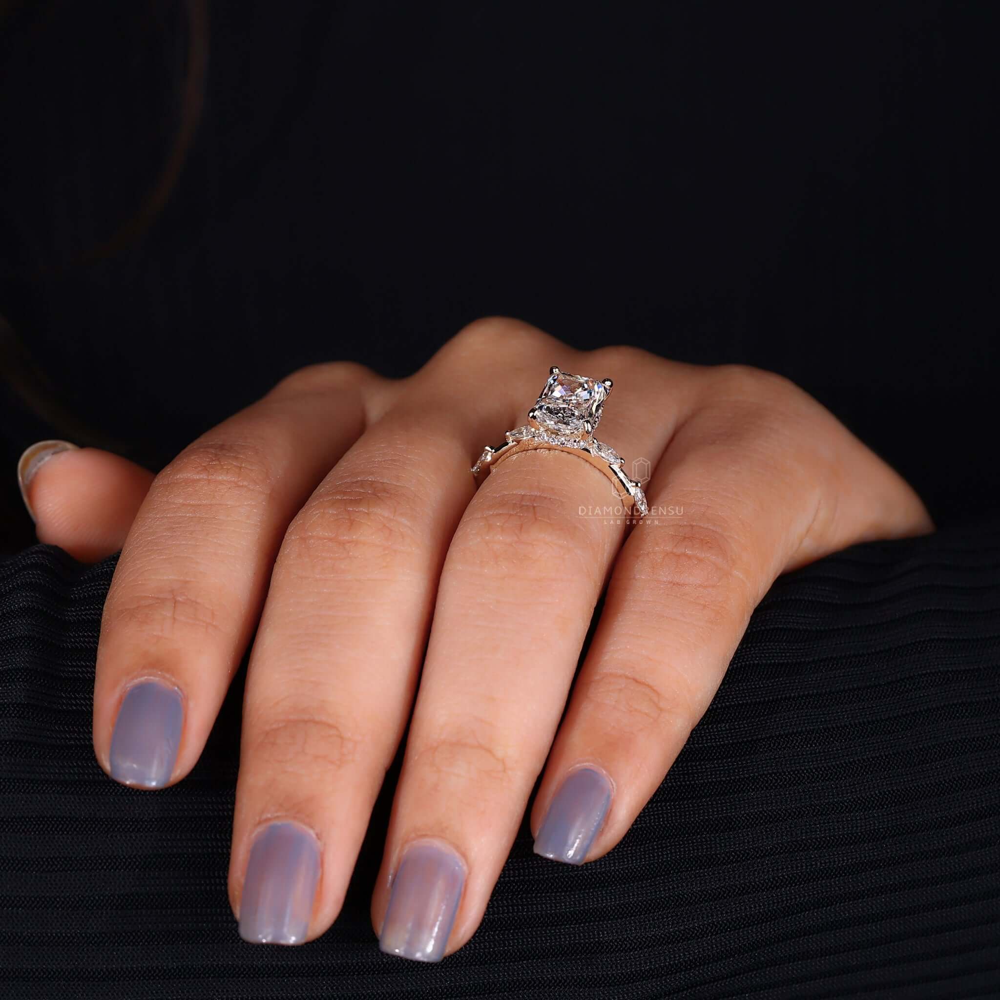 A side stone engagement ring with intricate accents, making it a standout choice.