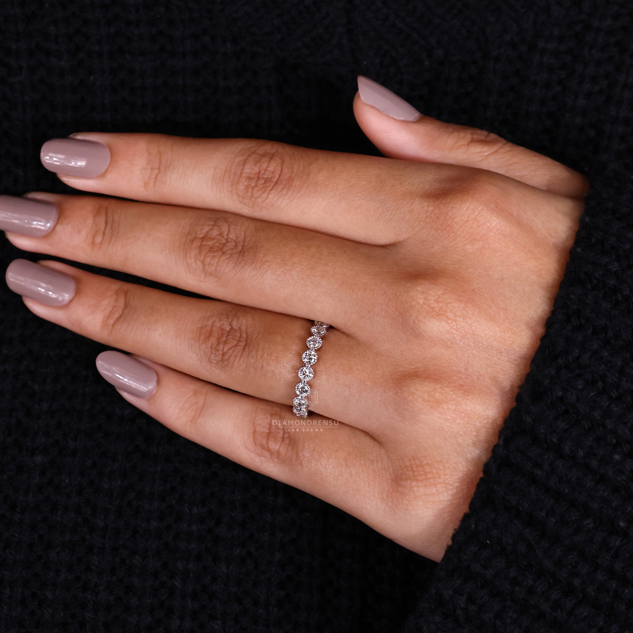 Round cut diamond wedding band with bezel setting.
