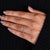Round cut diamond wedding band with bezel setting.

