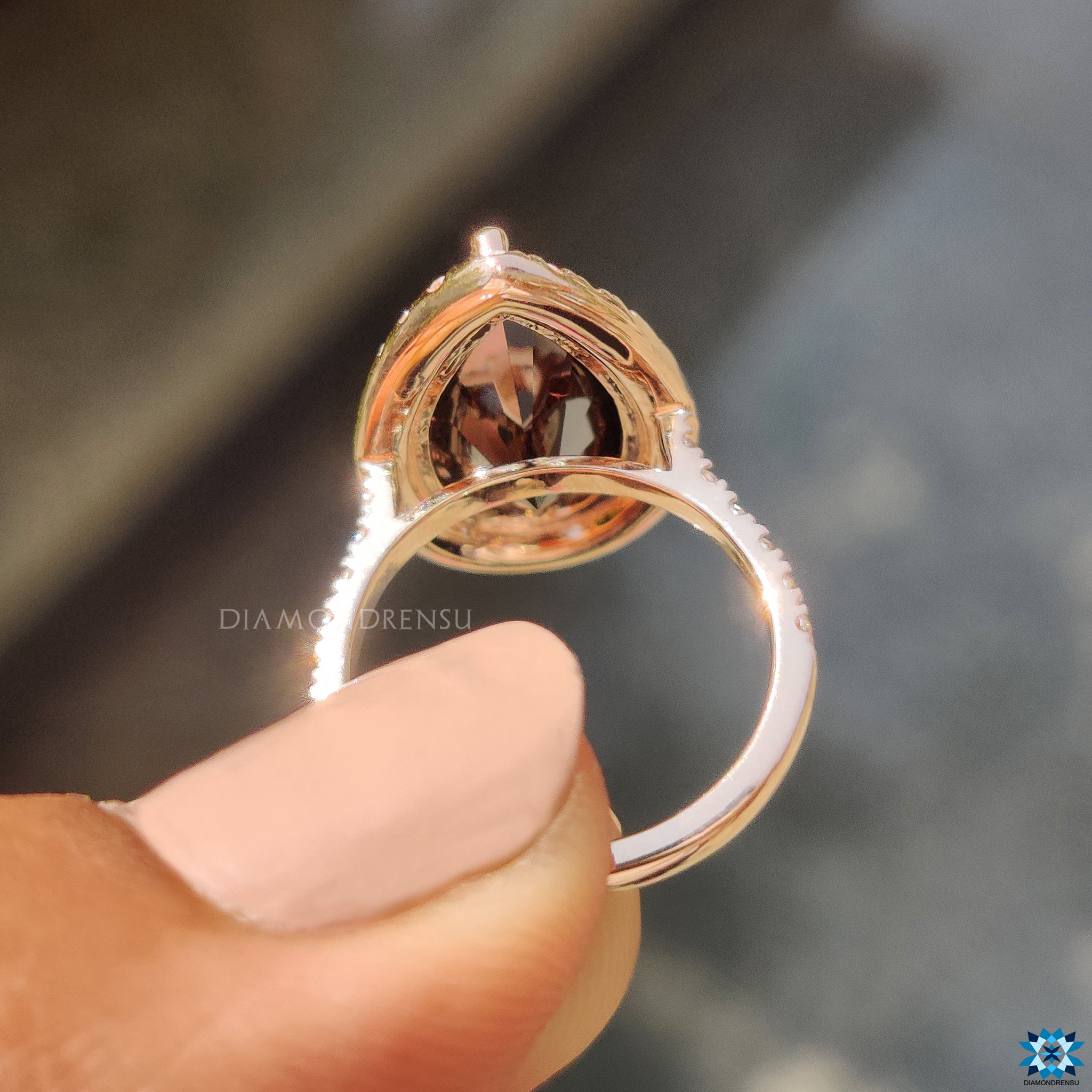 Buy engagement ring with pear black moissanite and round halo setting.
