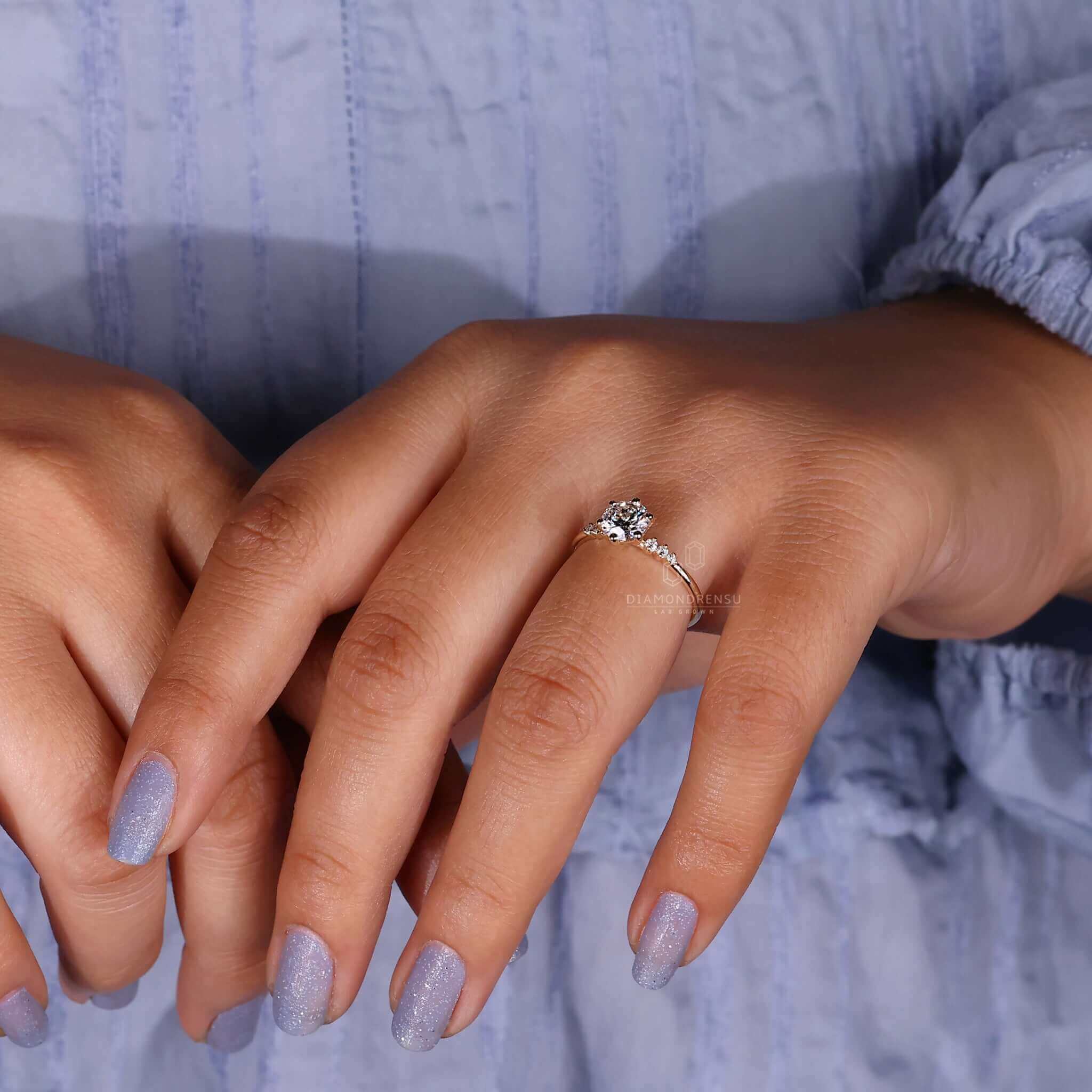 Unique engagement ring with a round cut diamond and fine detailing.