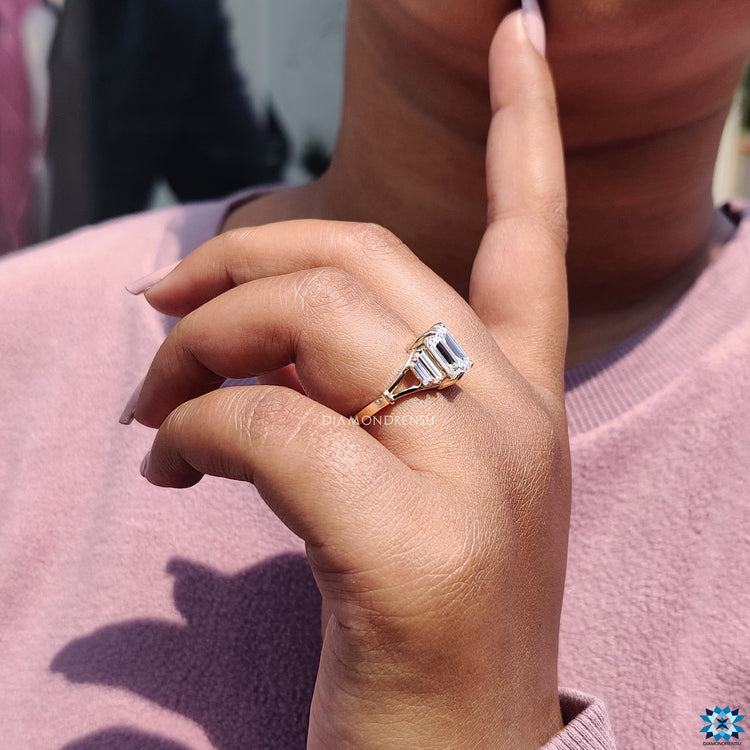 Handmade yellow gold ring with emerald cut center.
