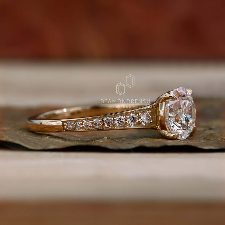 Round engagement ring featuring a brilliant cut diamond and a tapered band, perfect for a classic engagement look.
