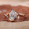 Pear cut diamond ring with a stunning half bezel design.