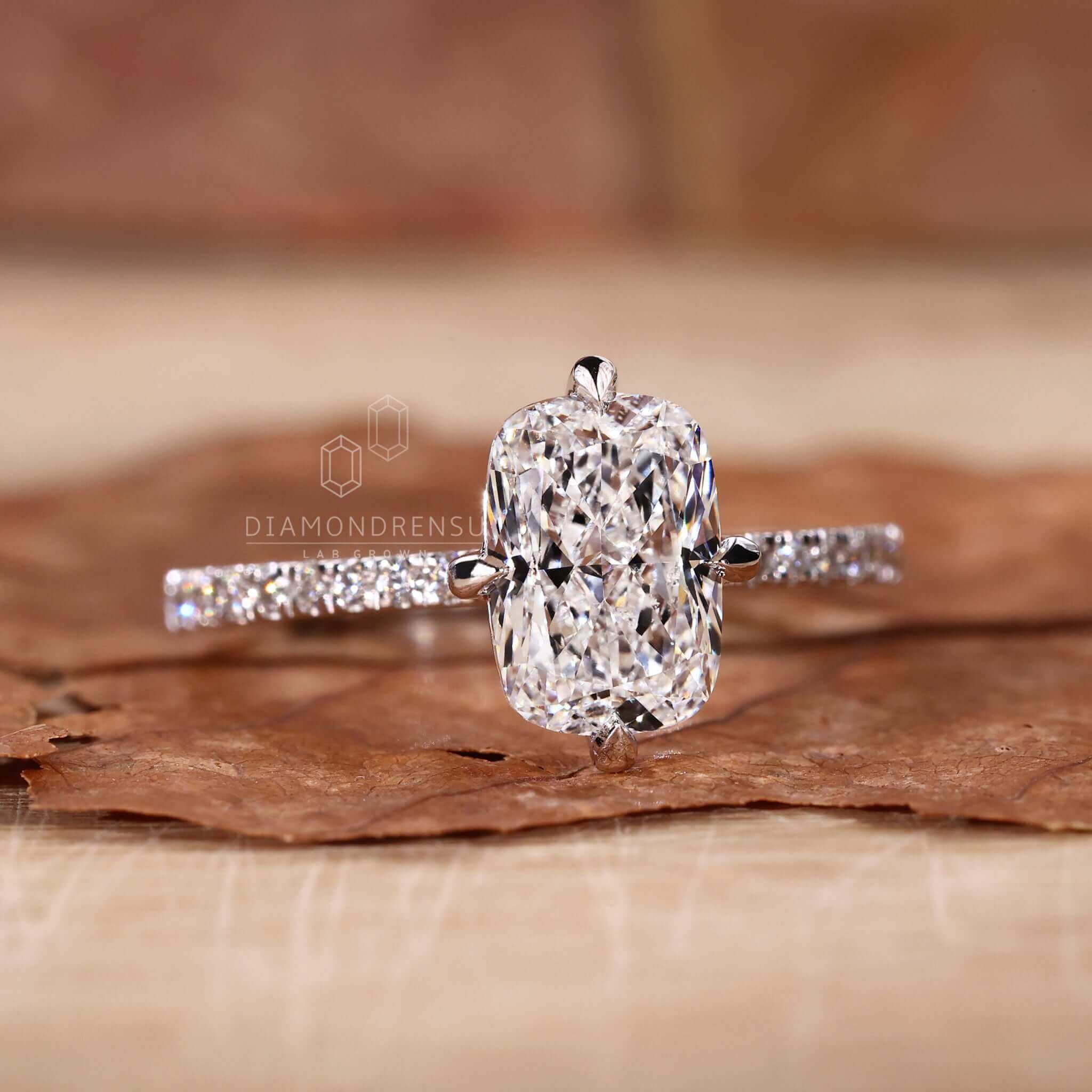 Elongated cushion diamond ring paired with a gold pave ring for classic elegance.