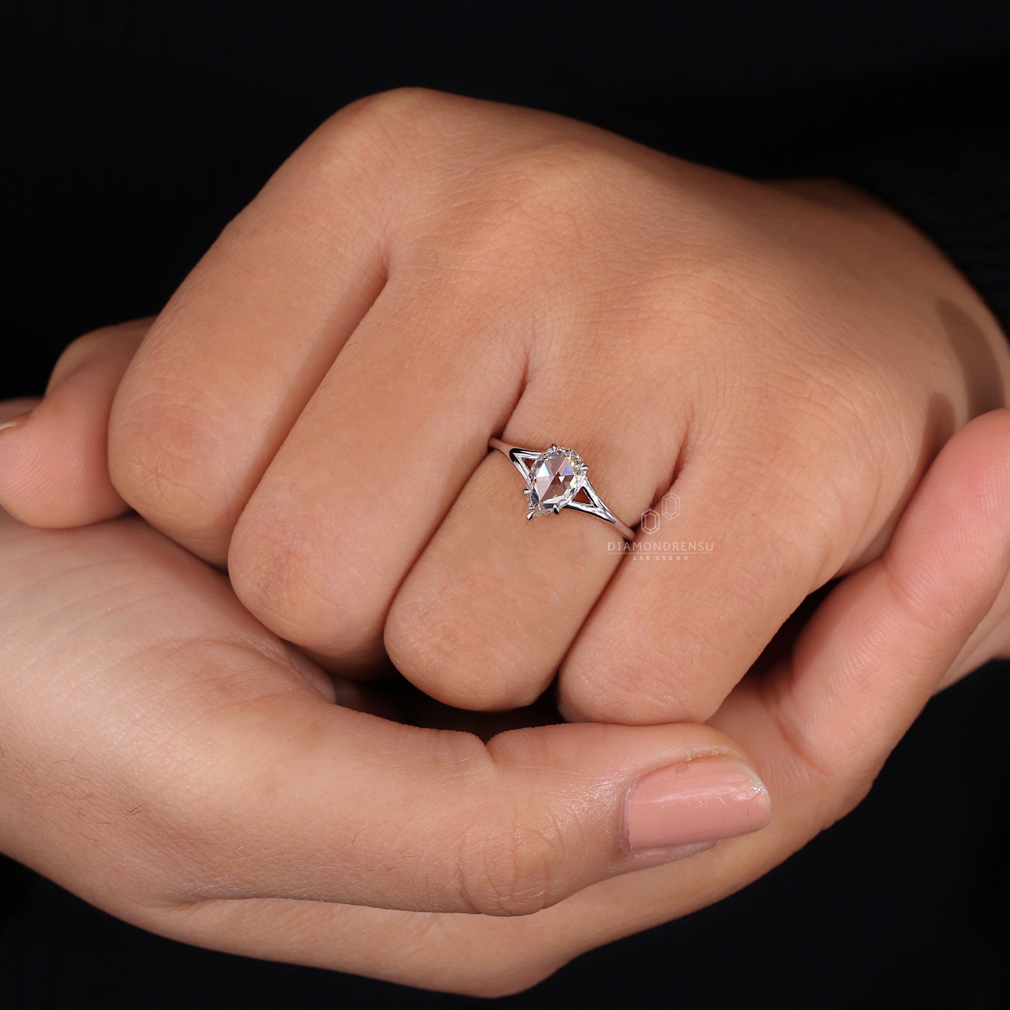 Unique engagement ring is made using white gold and split shank.
