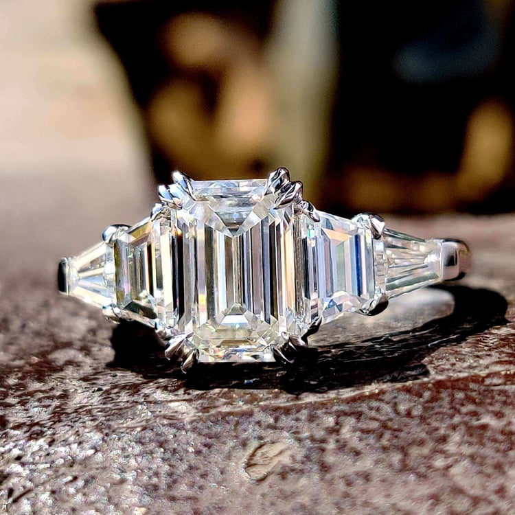 Five stone emerald cut moissanite engagement ring in white gold.
