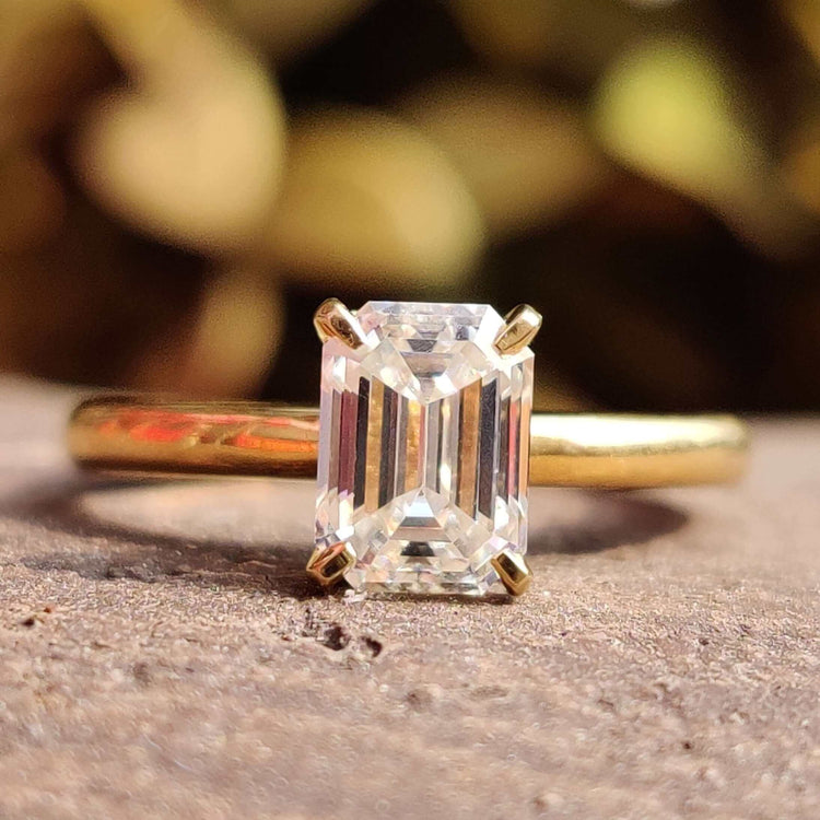 Emerald cut moissanite solitaire ring.
