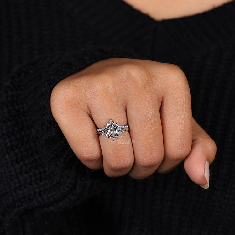 Muse setting ring with marquise and round side stone design.
