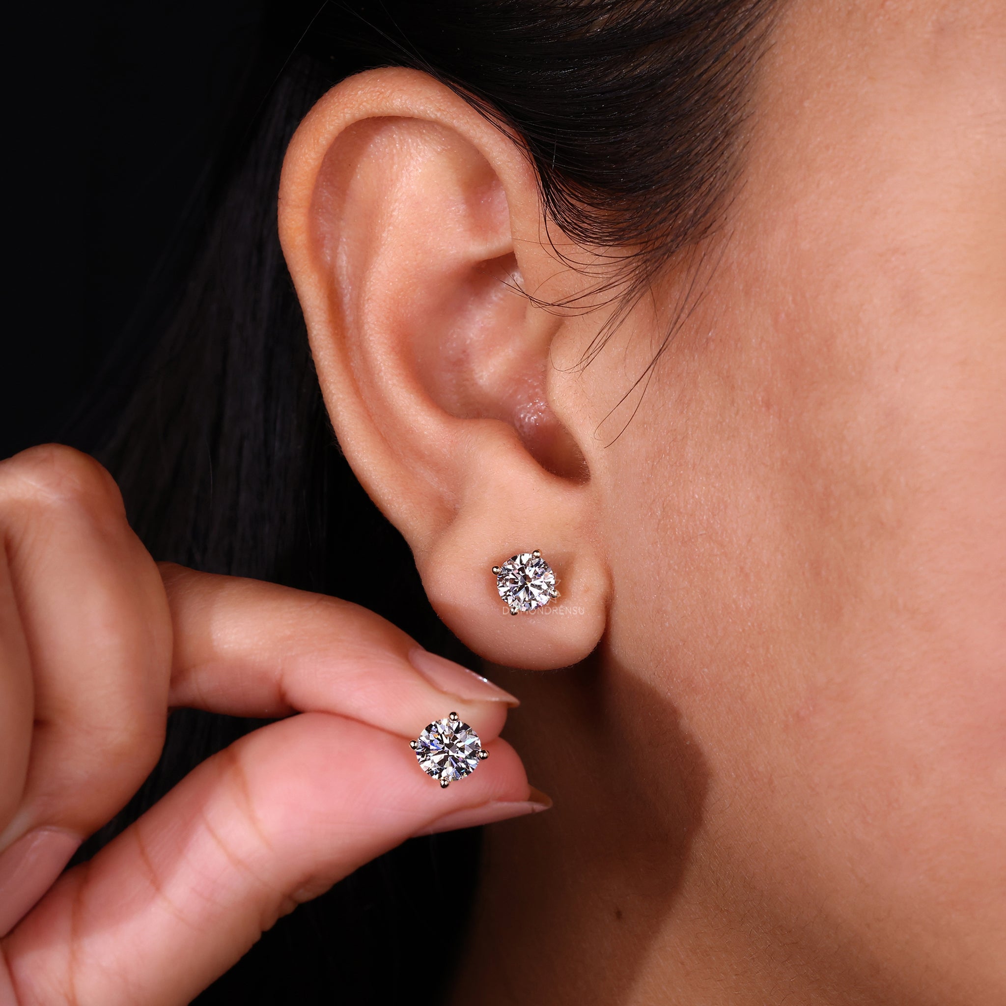 Lab grown diamond earrings set in gold 4 prong settings.