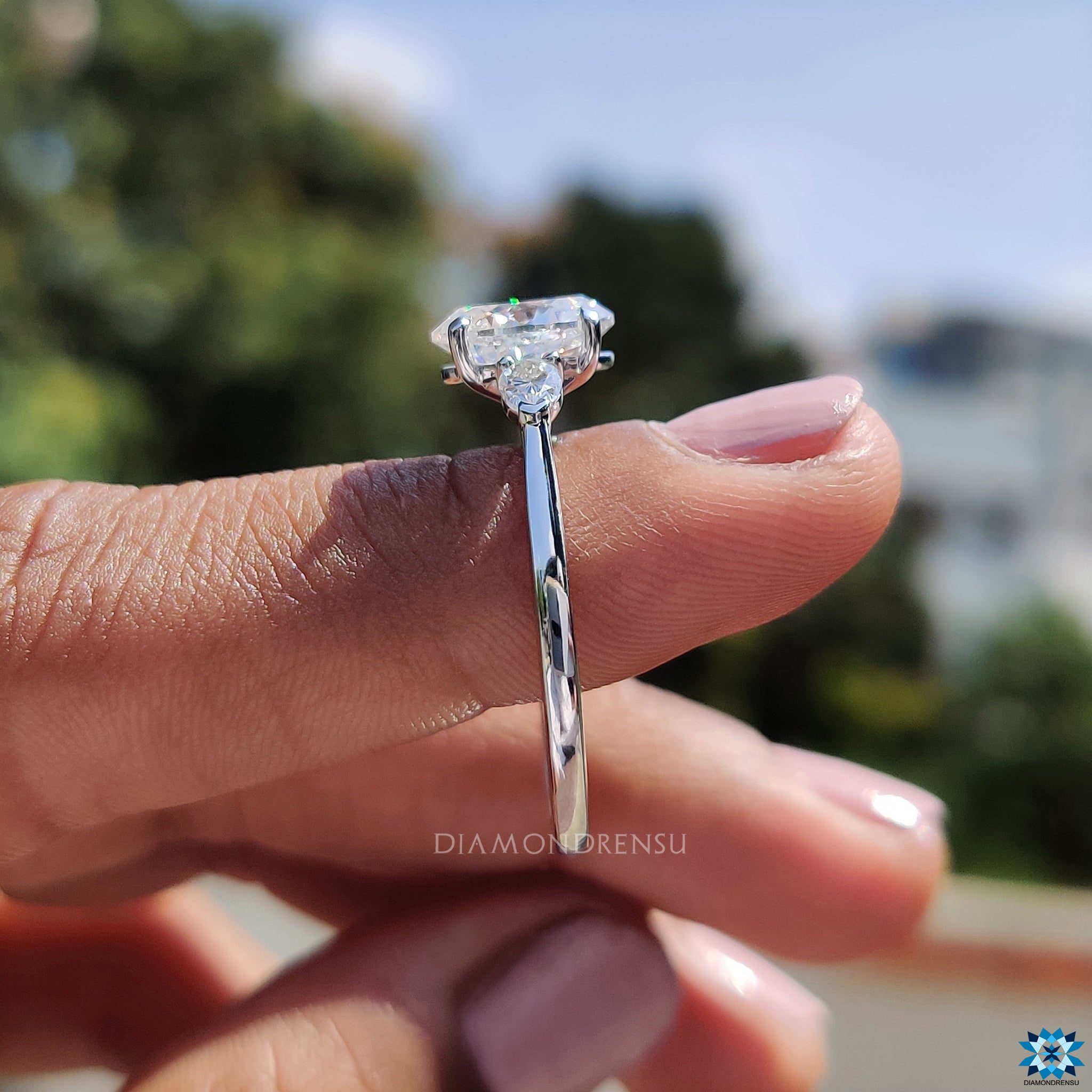 Handmade jewellery ring with oval and pear moissanite arrangement.
