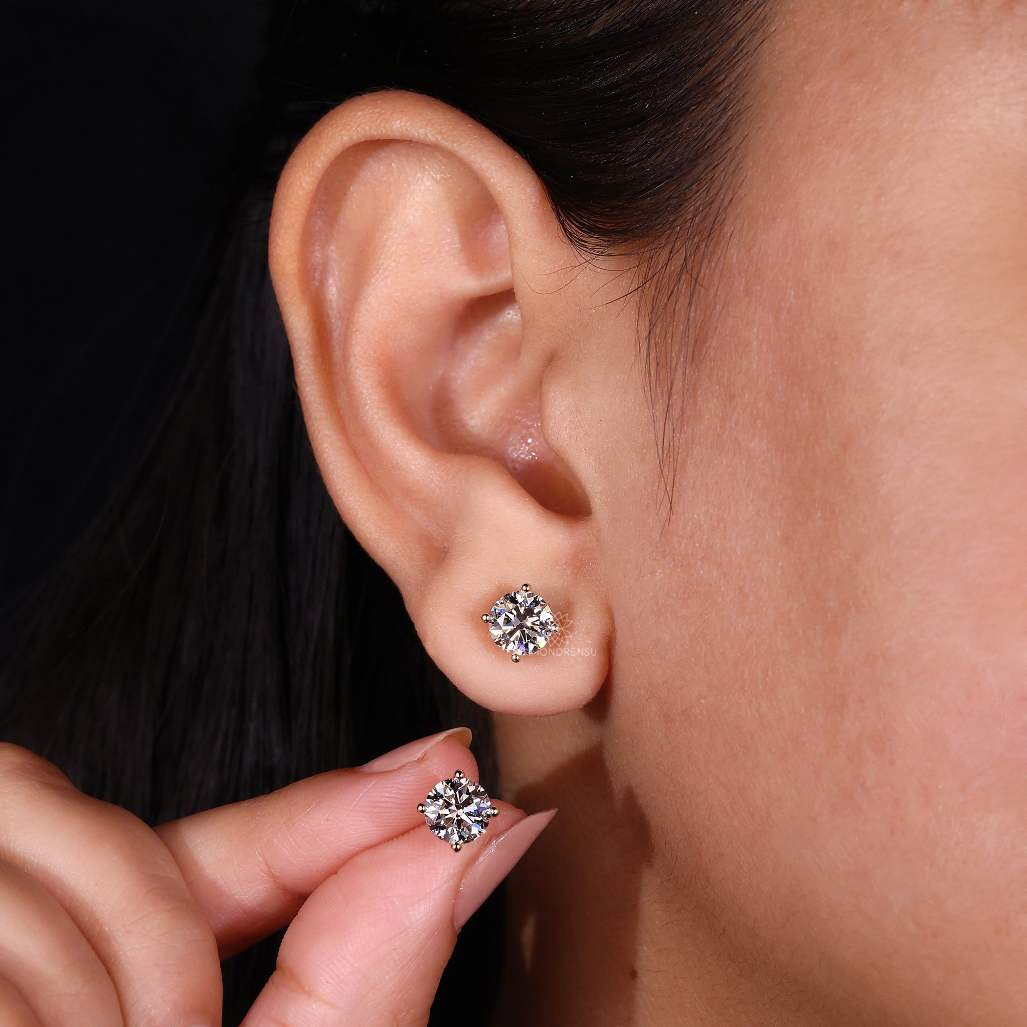 Diamond stud earrings UK with secure 4 prong yellow gold setting.