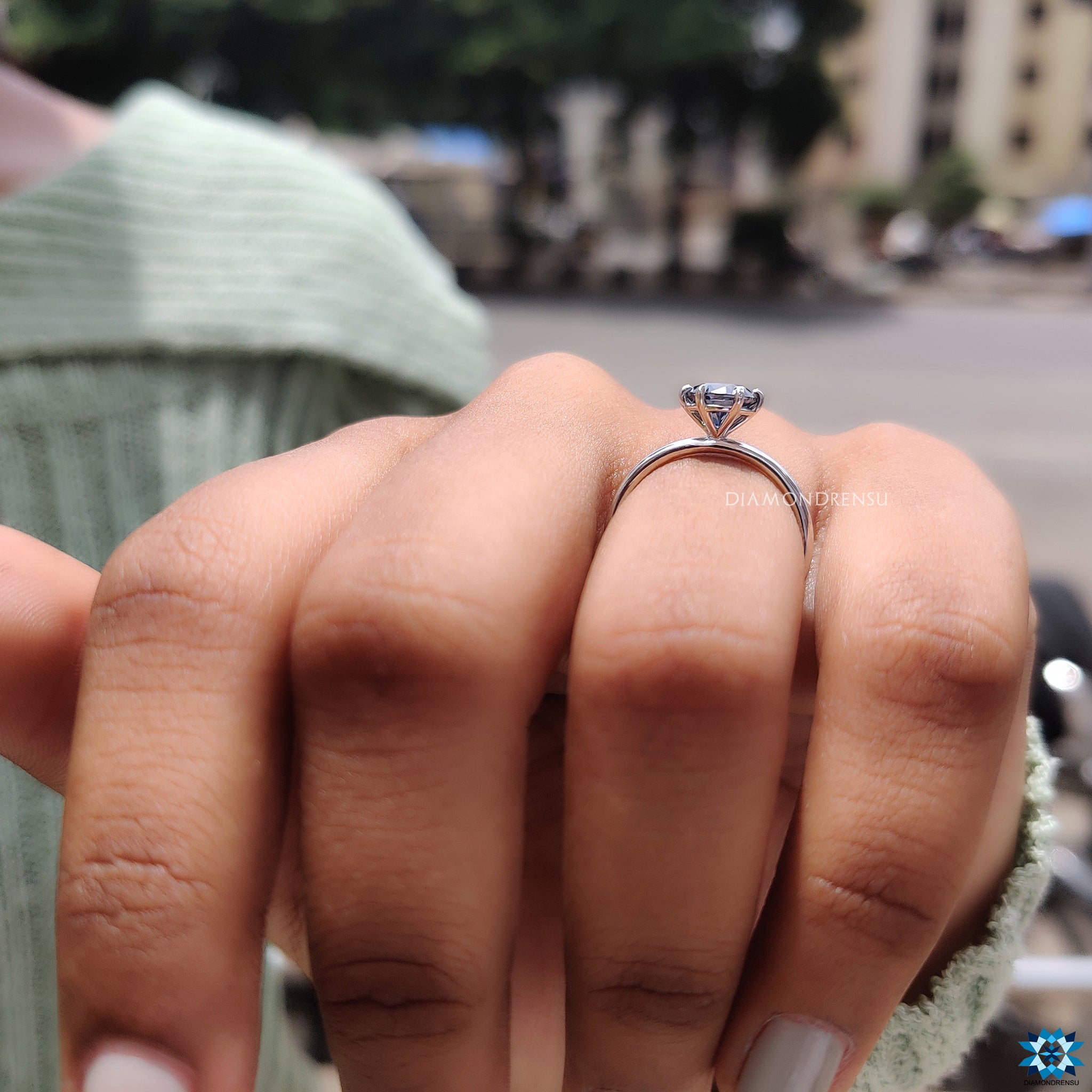 Moissanite engagement ring in a minimalist solitaire white gold mount.
