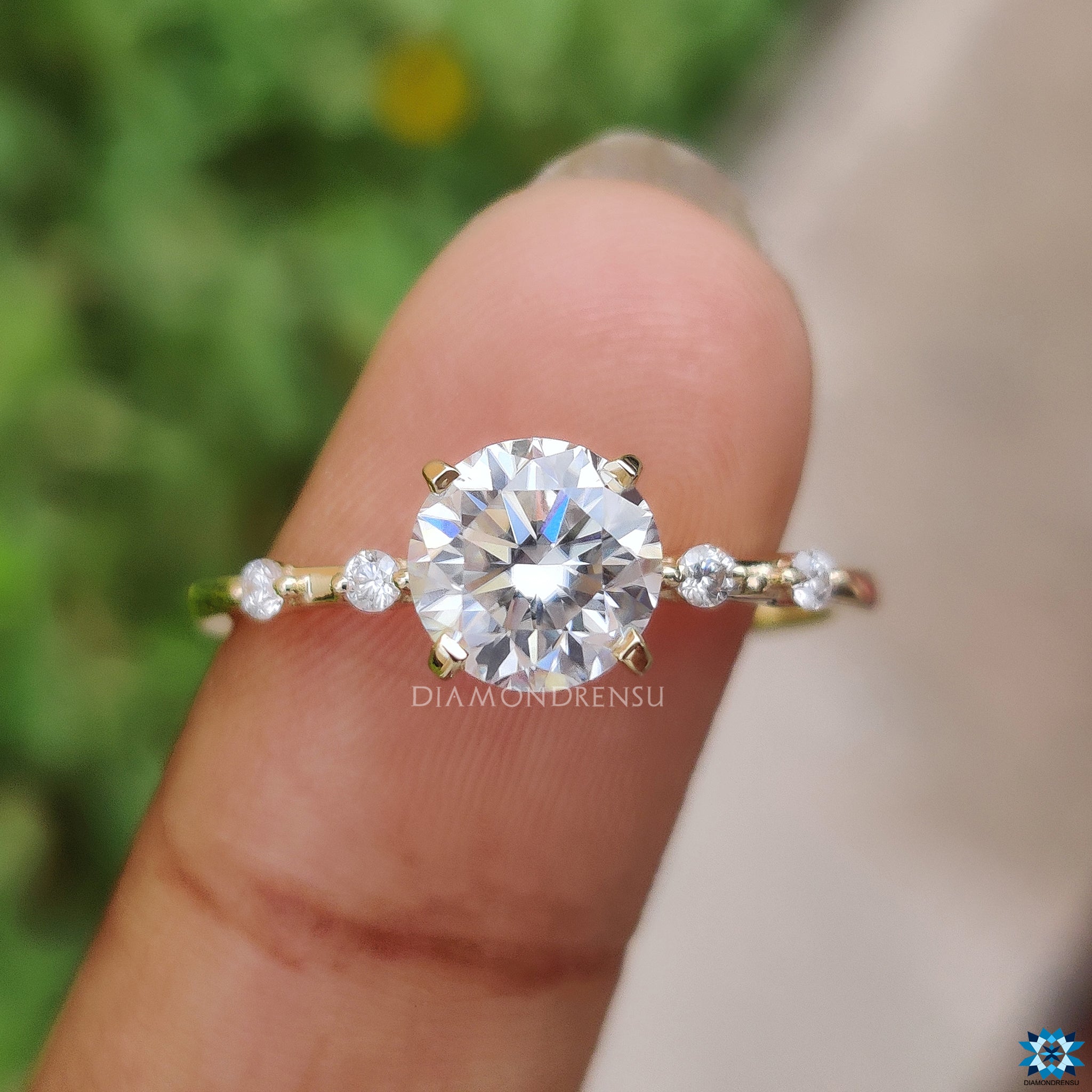 Yellow gold engagement ring with 4 prong setting and brilliant moissanite.
