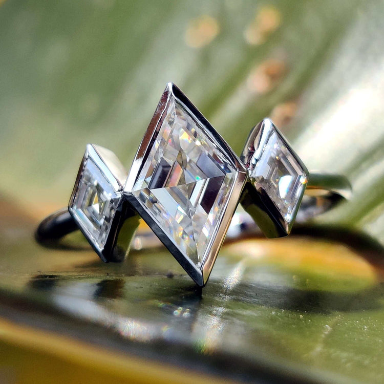 Lozenge cut moissanite engagement ring in white gold.
