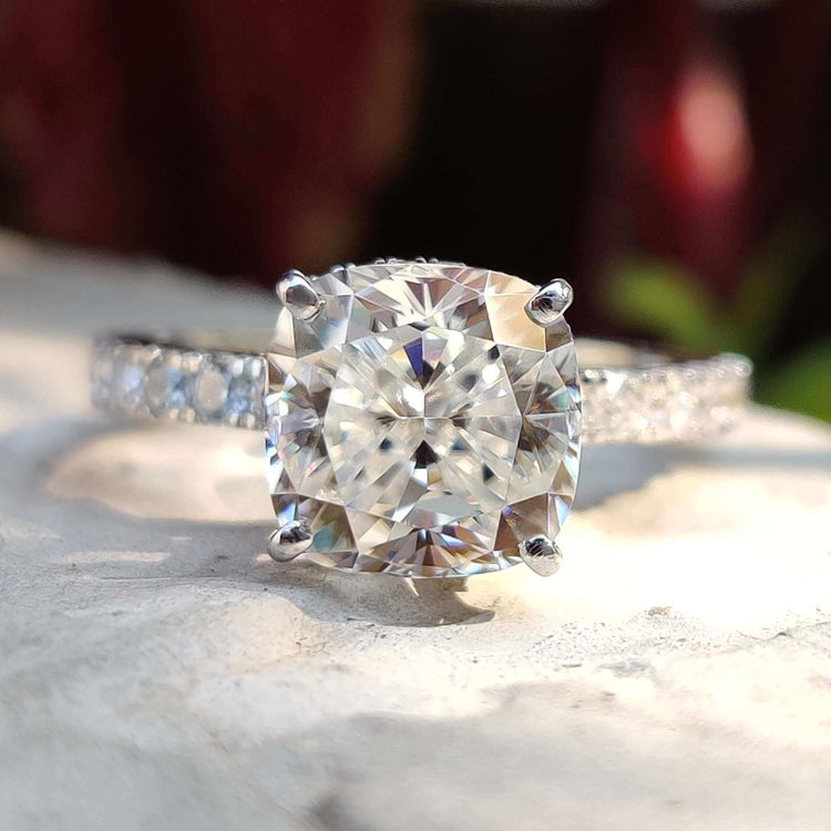 Cushion cut moissanite ring with double halo.
