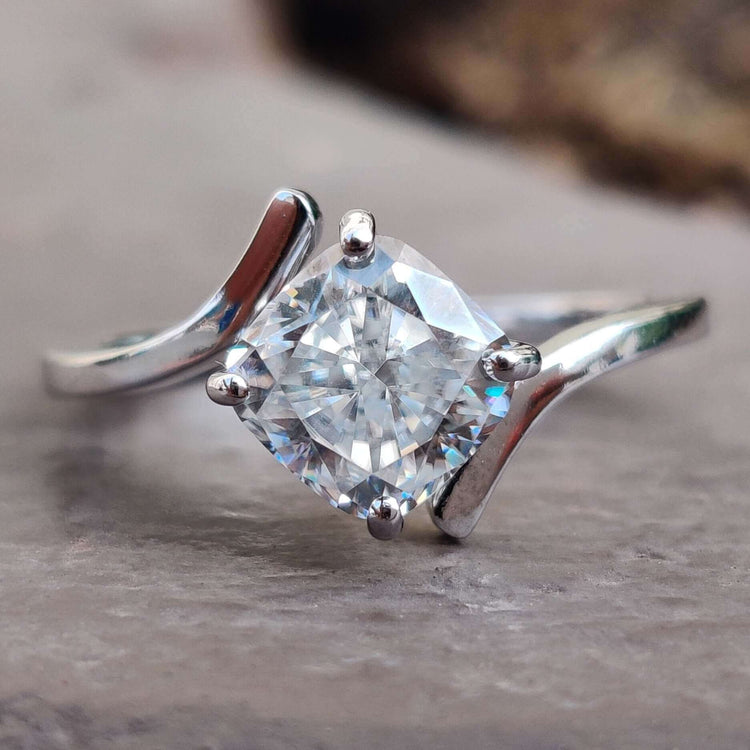 Cushion cut moissanite engagement ring in white gold.
