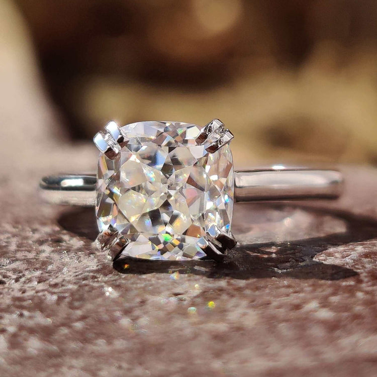 Cushion Rensu cut solitaire moissanite ring in white gold.
