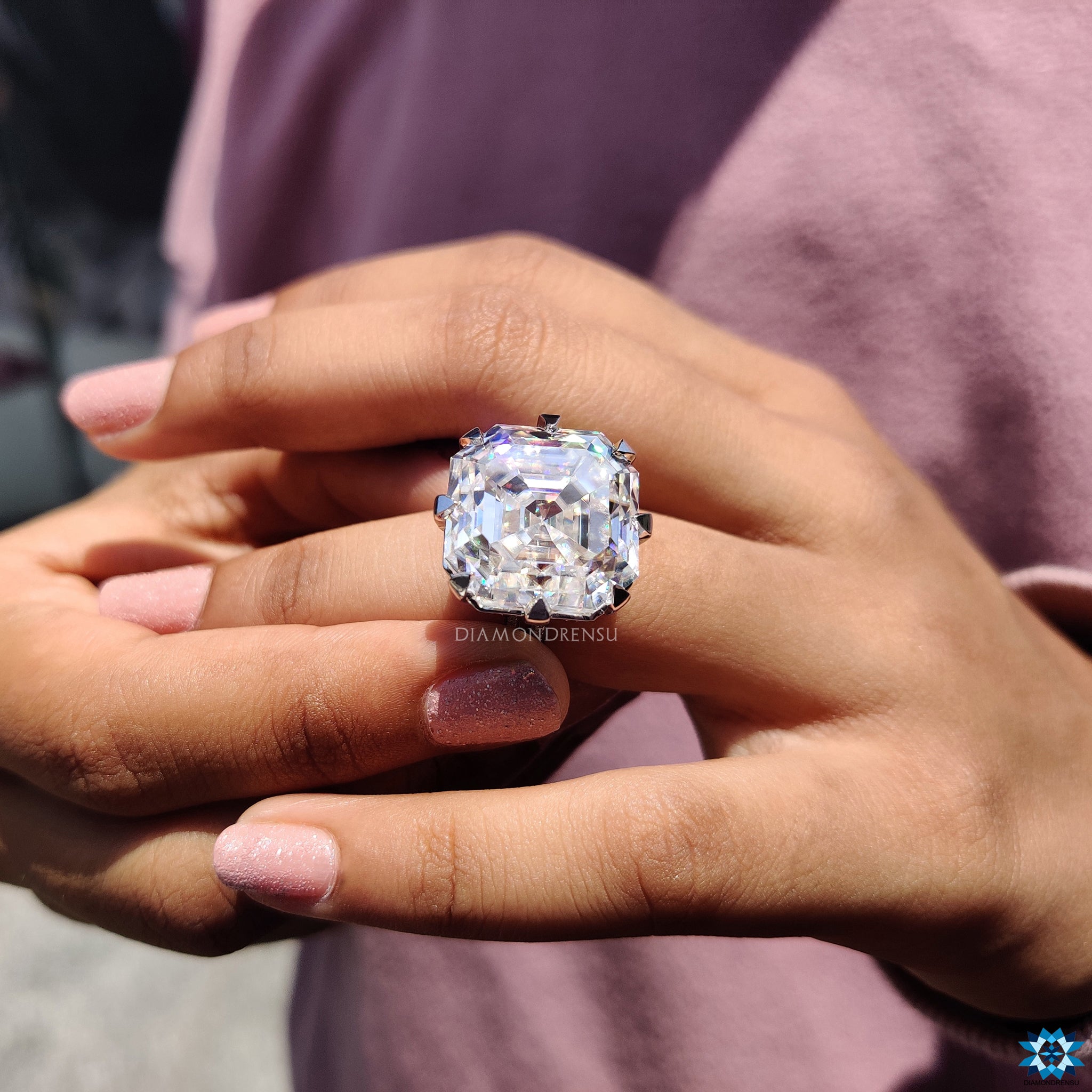 UK engagement ring with split shank and round side moissanites.
