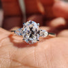 Oval and pear engagement ring with three stone moissanite design.
