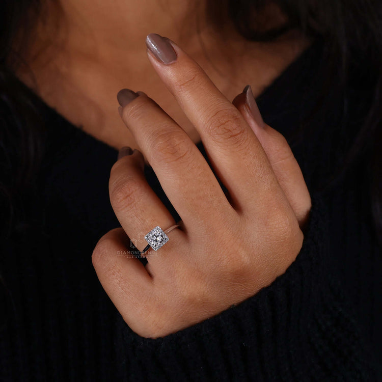 Princess cut halo engagement ring with dazzling accents.