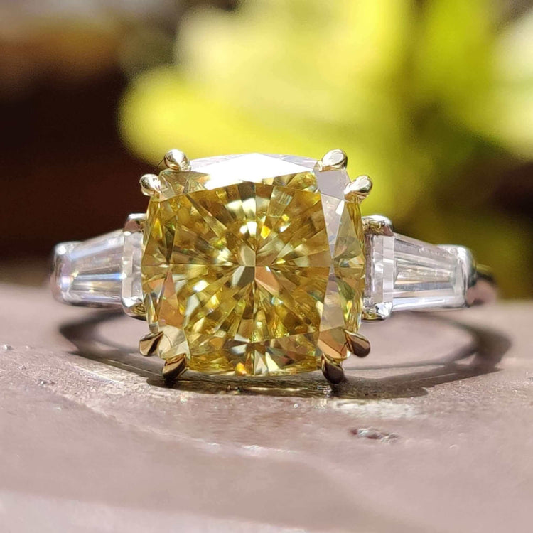 Cushion cut engagement ring with tapered baguette side stones.
