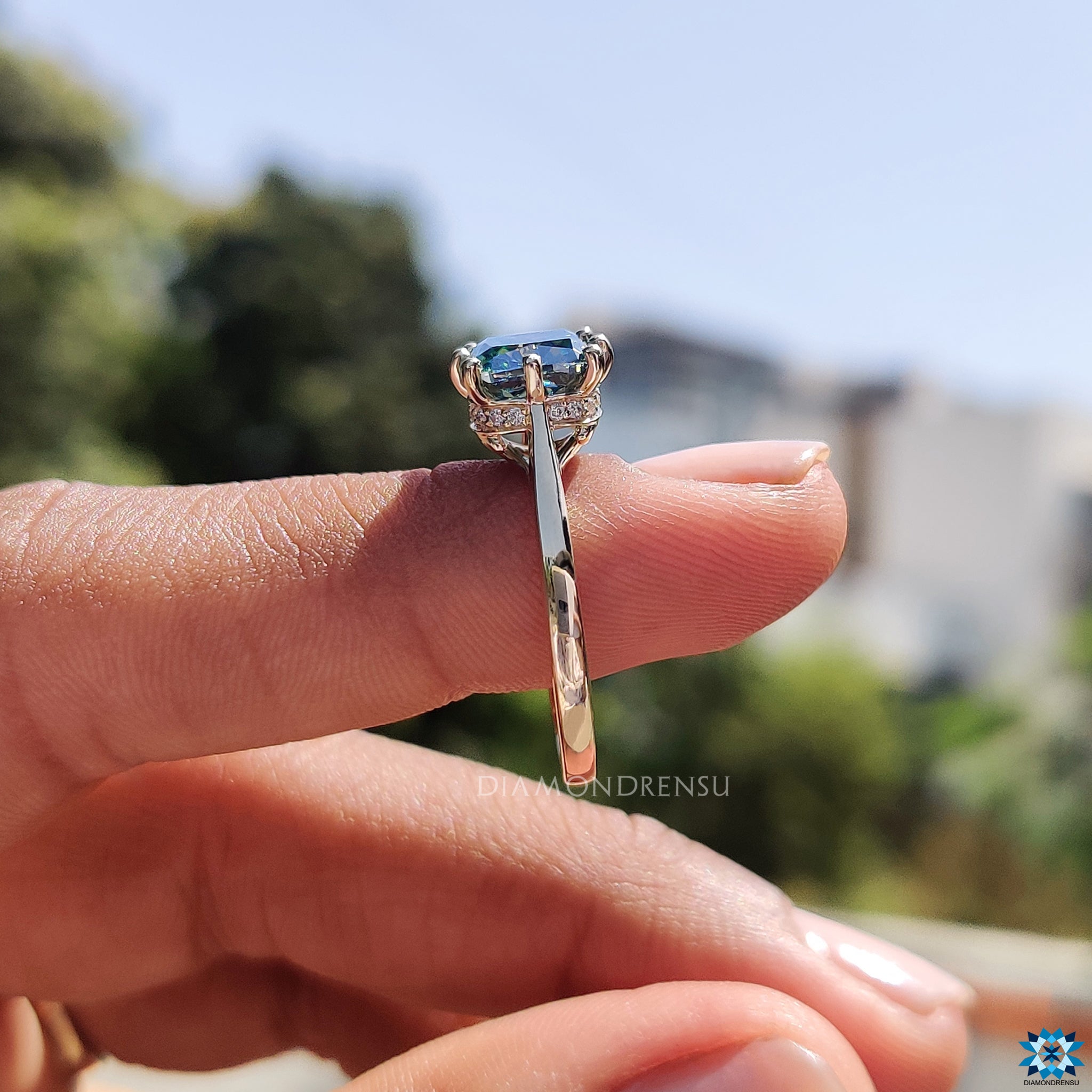 UK engagement ring in yellow gold with cushion moissanite and round halo.
