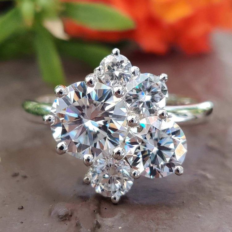 5 stone moissanite ring with round cut gems set in white gold.
