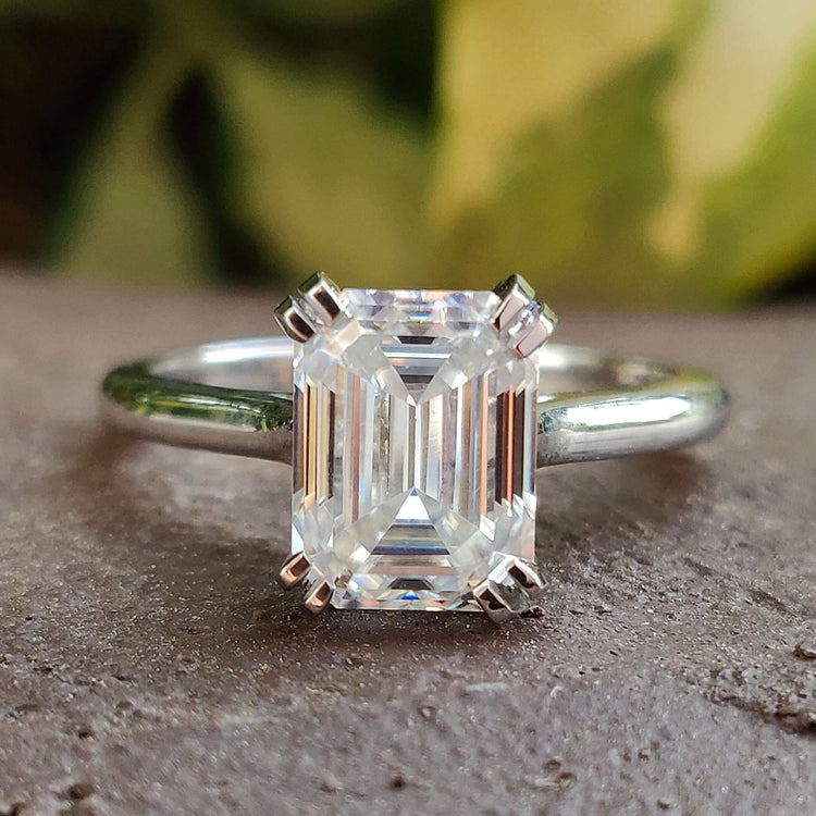 Emerald cut moissanite engagement ring in white gold.
