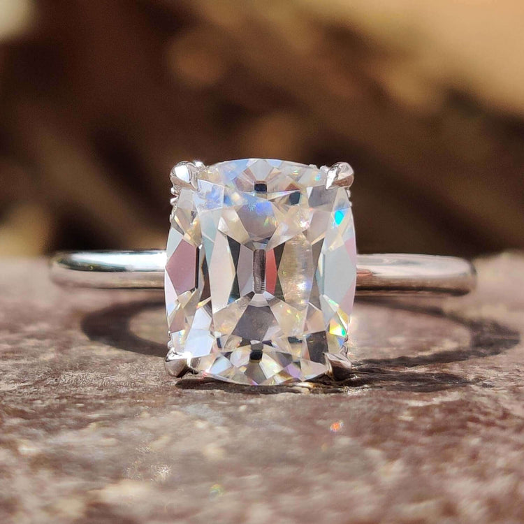 Old mine cut moissanite ring with cushion shape.
